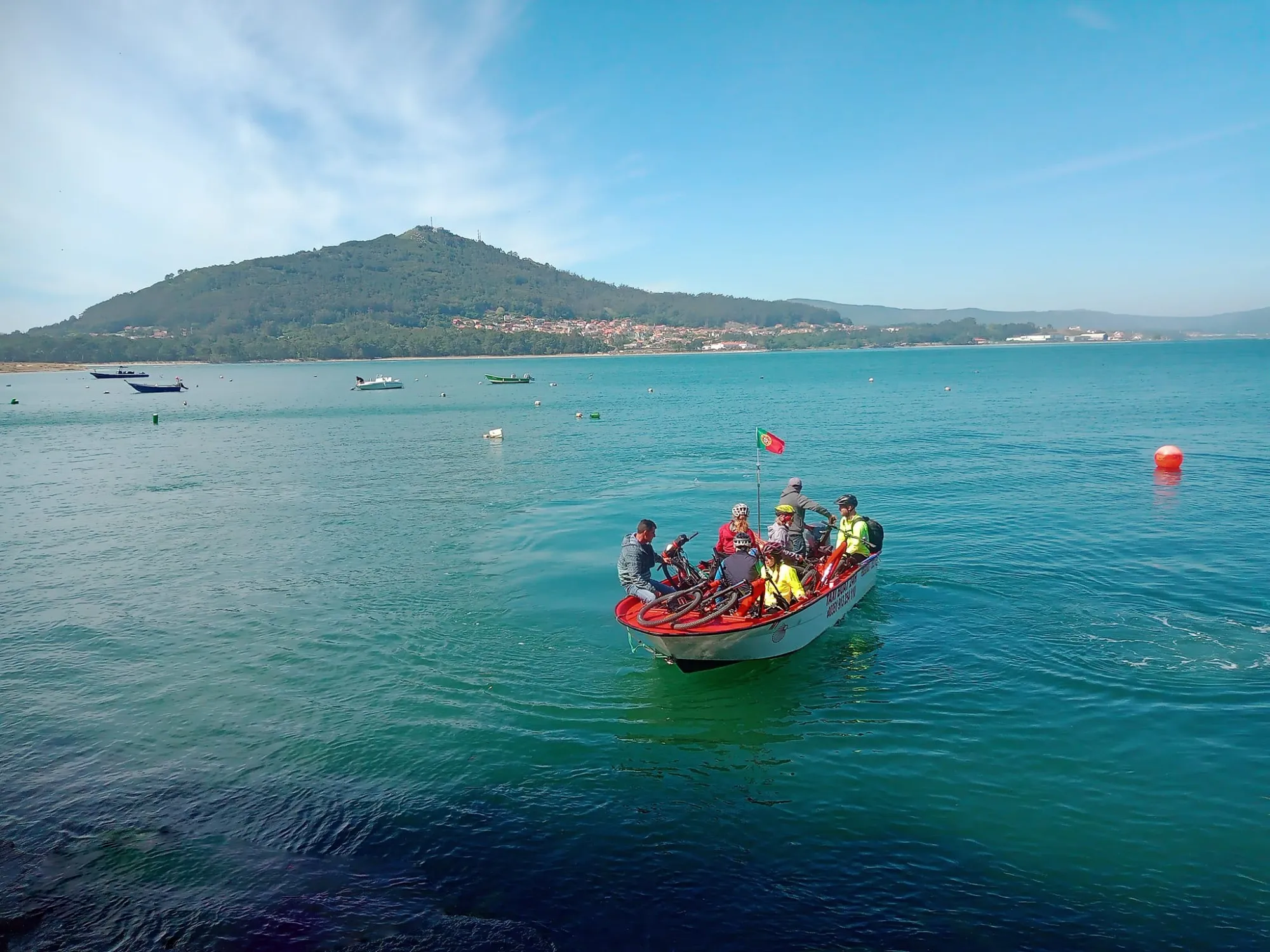 Cyclists and their bikes crossing the Minho together in one of our boats.